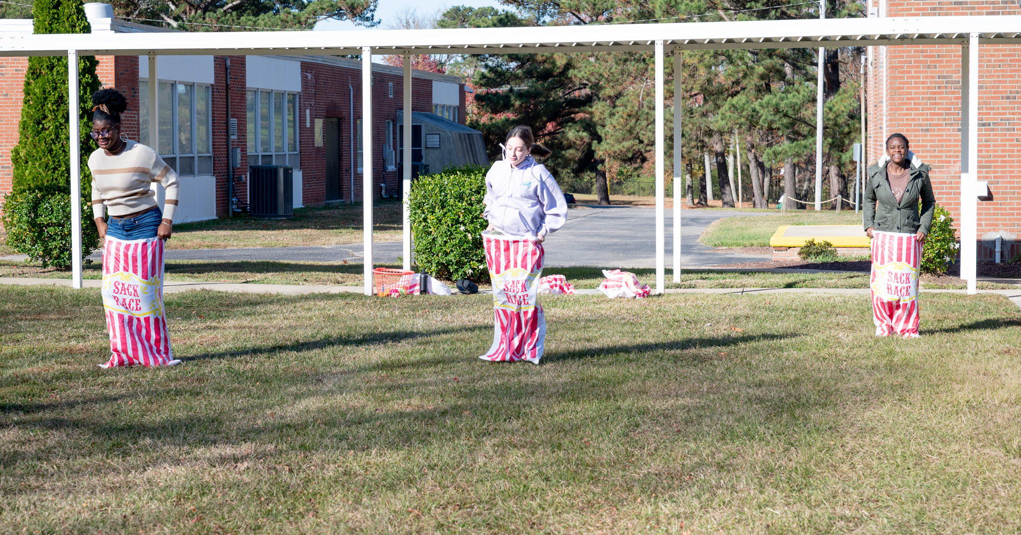 Fall Fest: Sack Race with three students