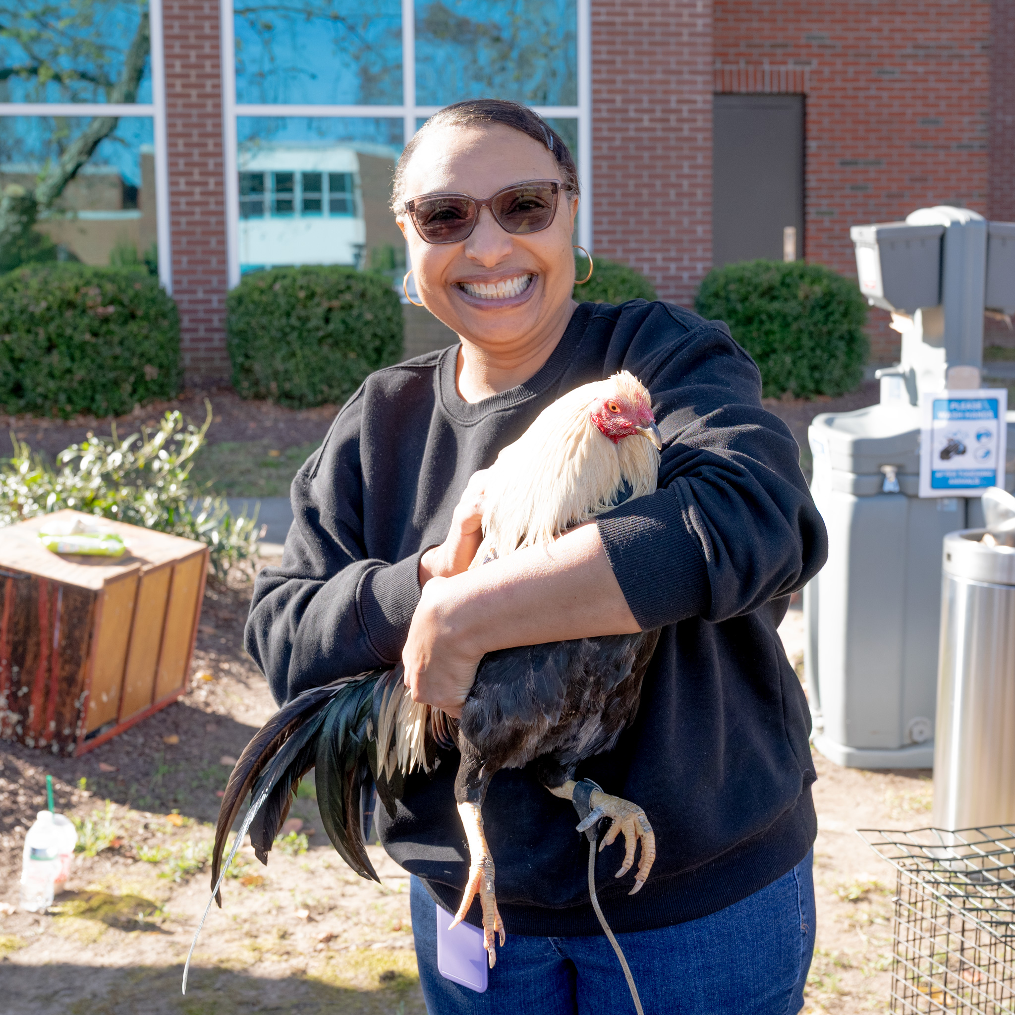 Fall Fest: Sandra smiles and holds a rooster