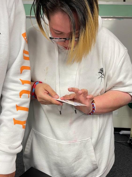 Student testing her blood.