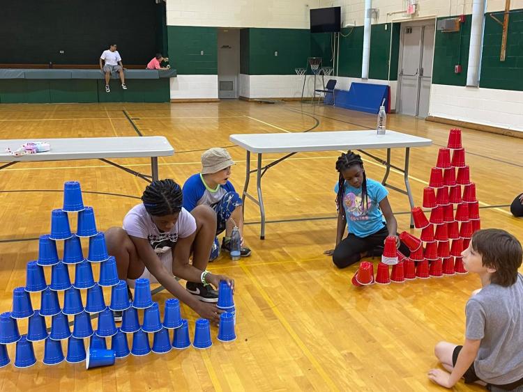 students stacking cups in a pyramid