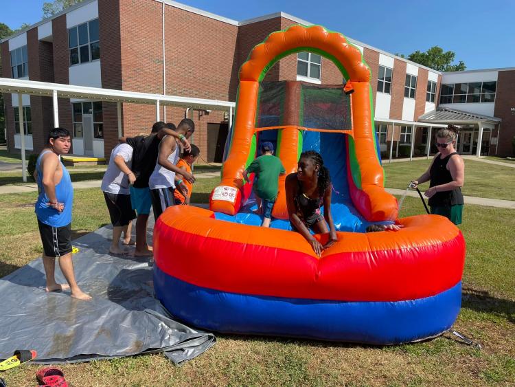 students on inflated waterslide