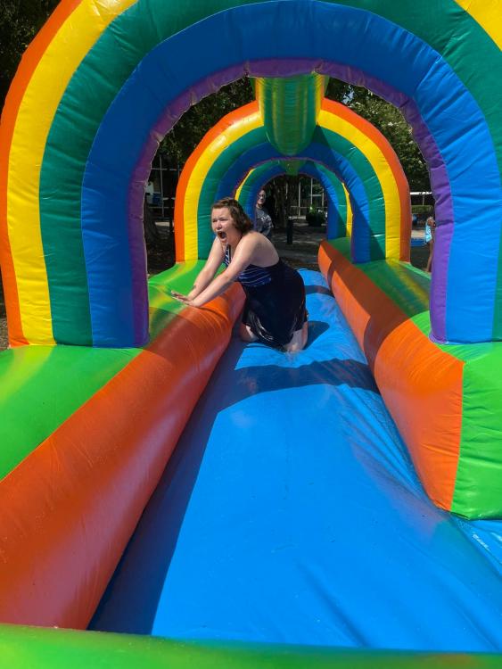 student on inflated waterslide