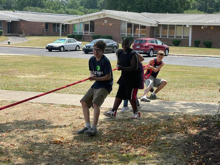 students pulling rope in tug-of-war