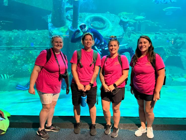Natasha, Heather, Krystal, Michaela standing in front of large aquarium