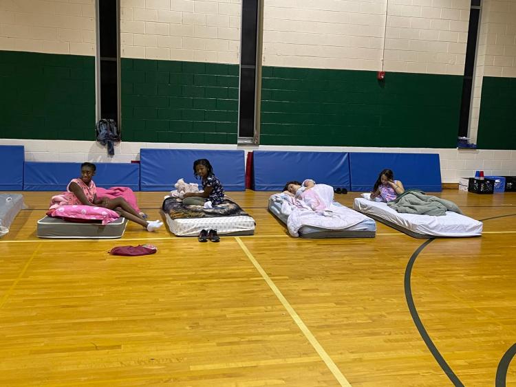 students on matresses in gym ready to go to sleep 