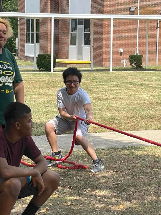 student pulling rope in tug-of-war