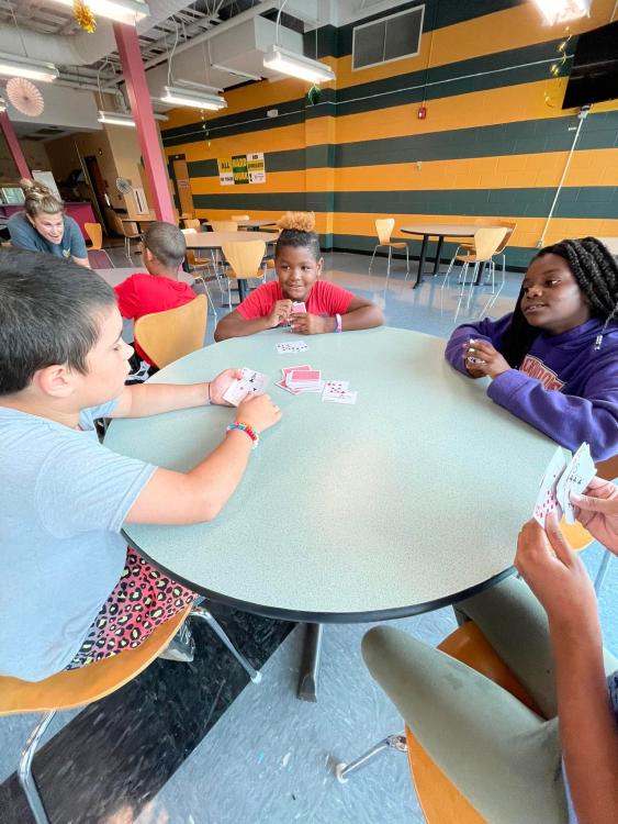 Students playing cars at table in Hornet's Nest 