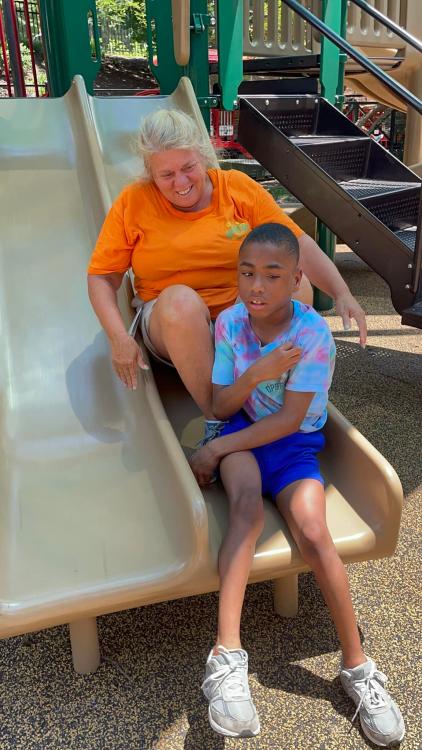 Kim and student on a slide