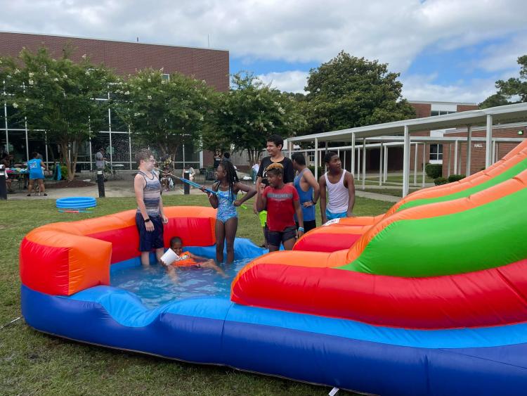 students on inflated water slide