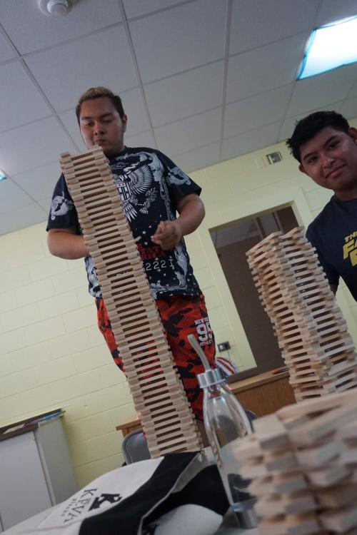 students stacking sticks in log cabin pattern