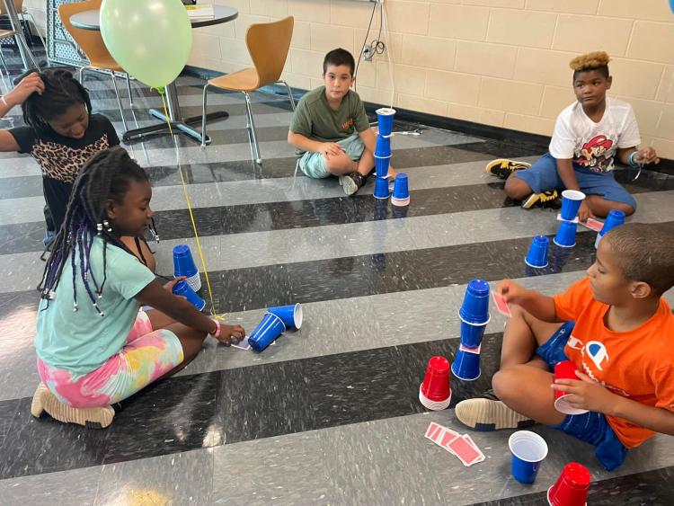 students stacking cups