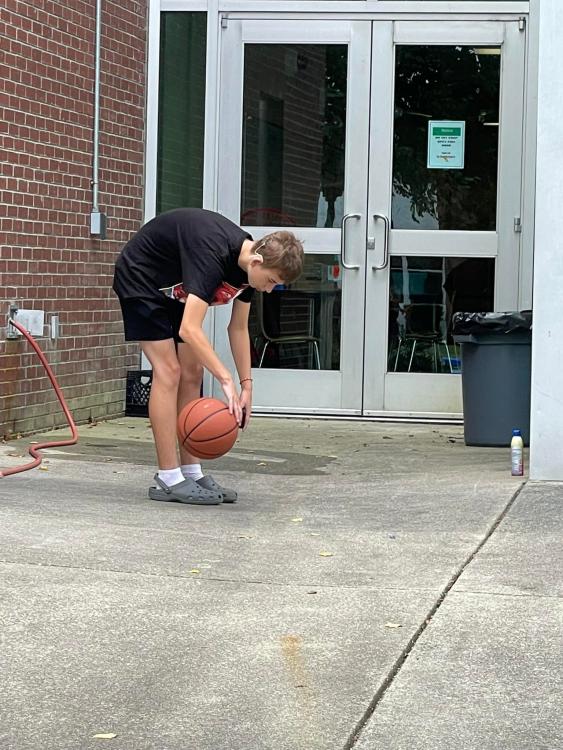 student with basketball