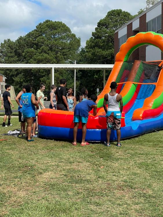 Students around inflated water slide