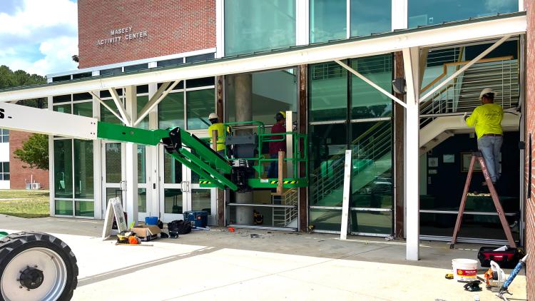 Installers put in new windows at Massey