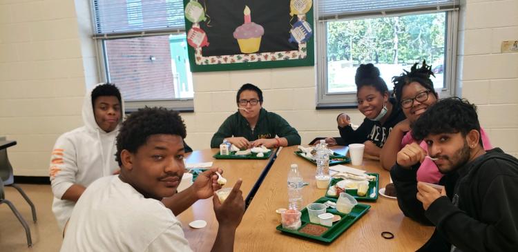 Students eating at table.