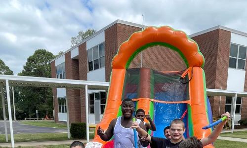 boys on the inflatable waterslide