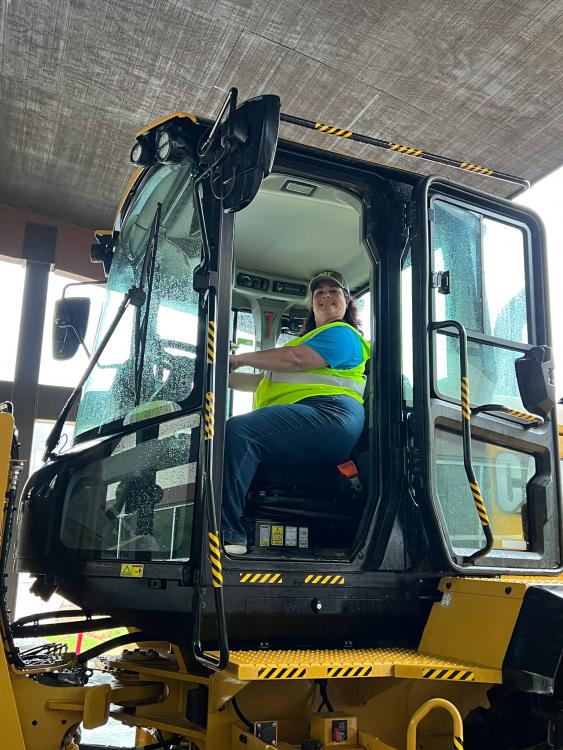 Teacher in a Caterpillar wheel dozer