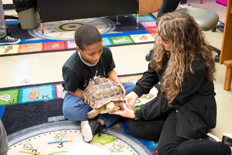Krystal and a Student holding a tortoise