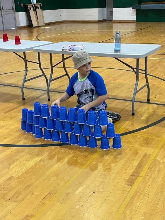 student stacking cups