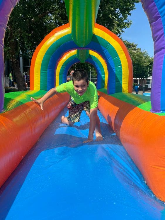 student on inflated waterslide