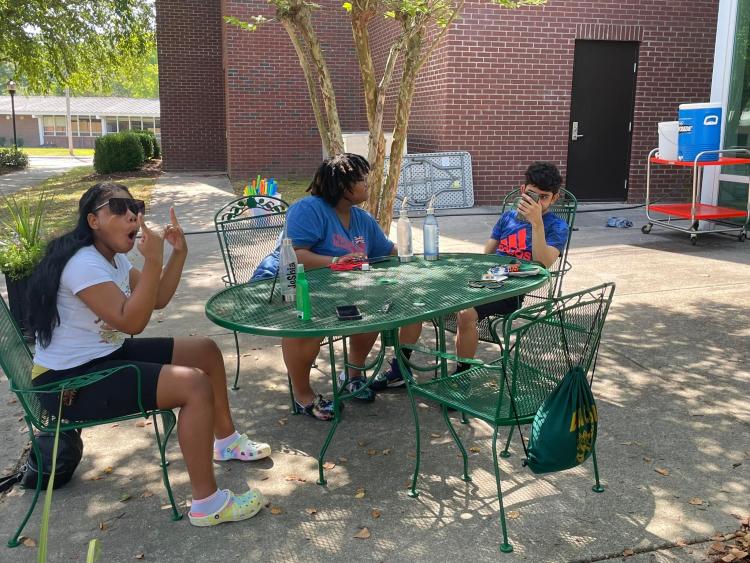 Students relaxing at a table outside the Hornet's Nest