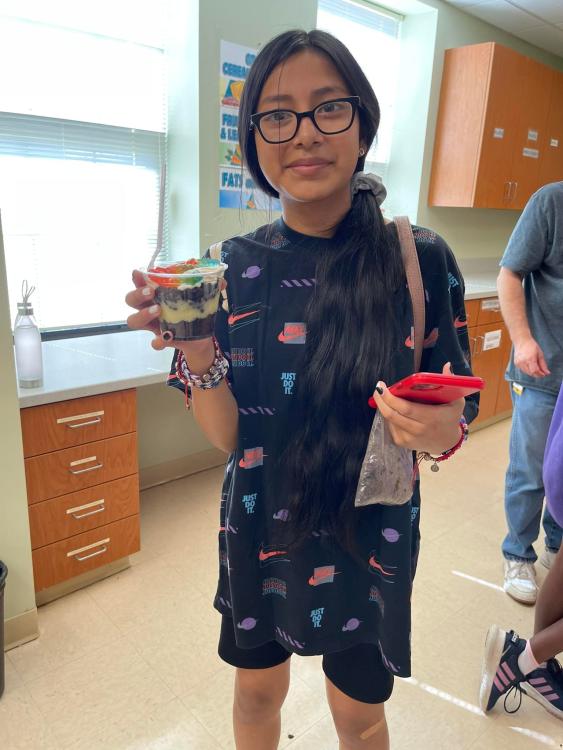 Student showing off 'dirt' dessert cup