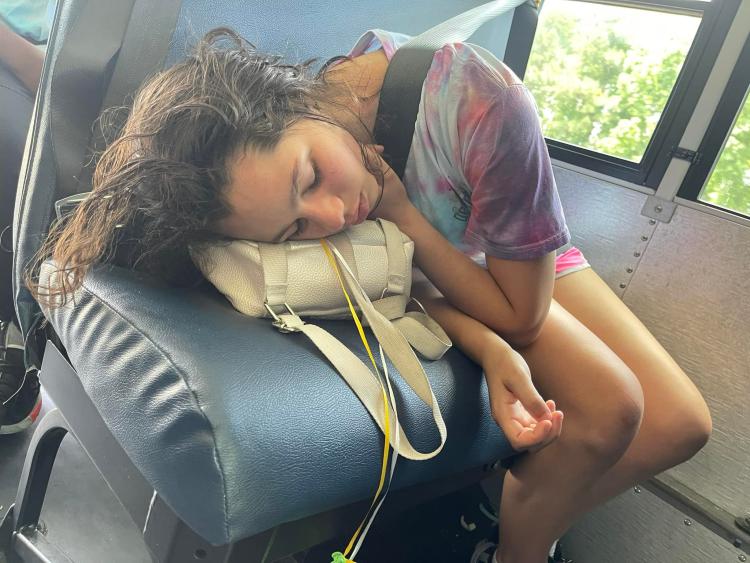 student asleep on her bag