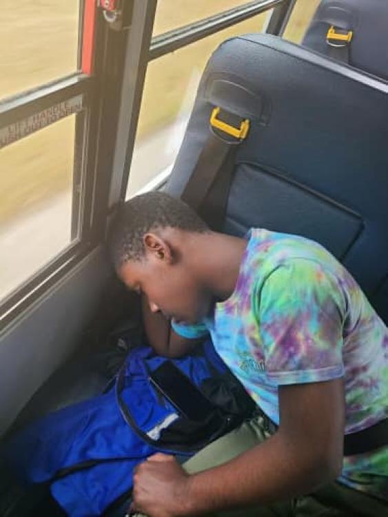 student asleep on bus