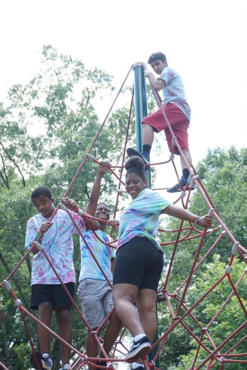 students climbing rope netting