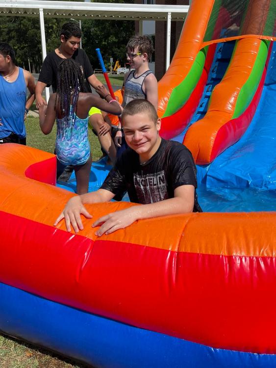students on inflated water slide