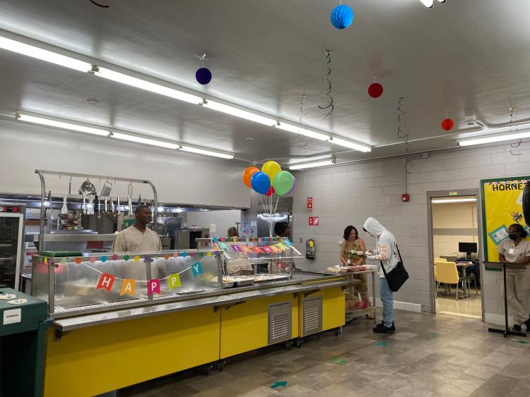 Cafeteria kitchen decorated with balloons.